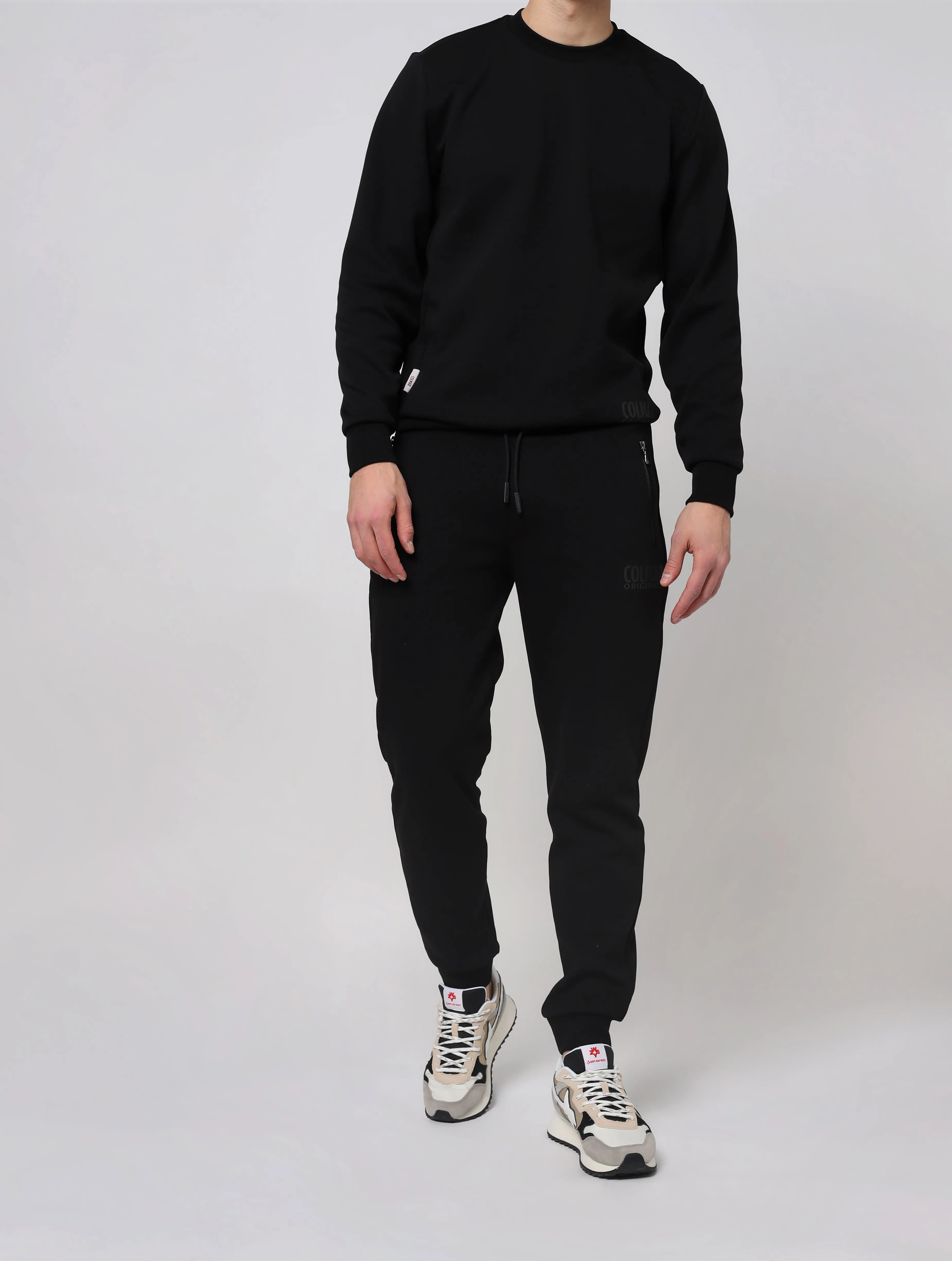 Pantaloni con vita elasticizzata in maglia a costine con coulisse di regolazione tasche laterali con zip taschino posteriore fon