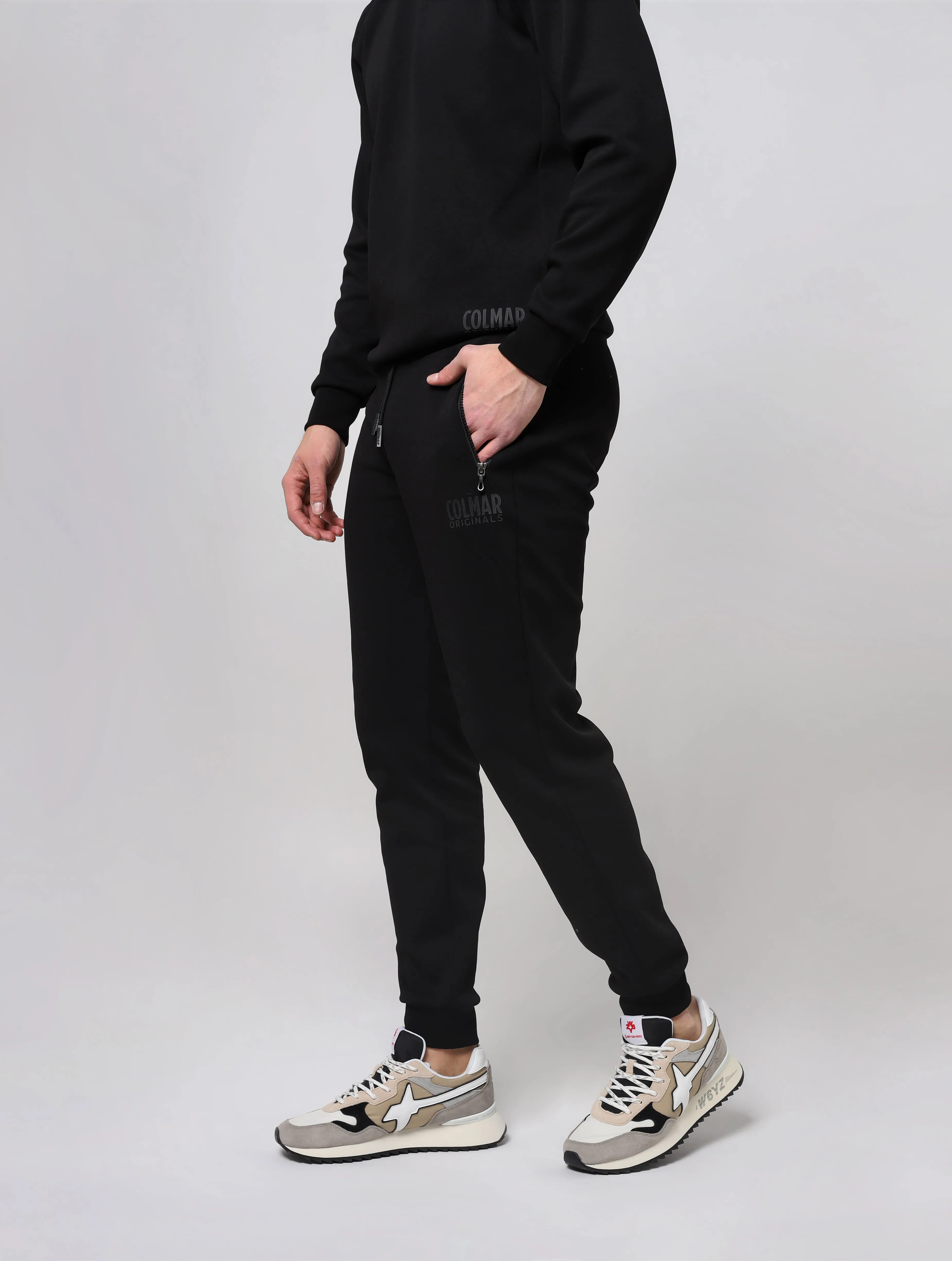 Pantaloni con vita elasticizzata in maglia a costine con coulisse di regolazione tasche laterali con zip taschino posteriore fon